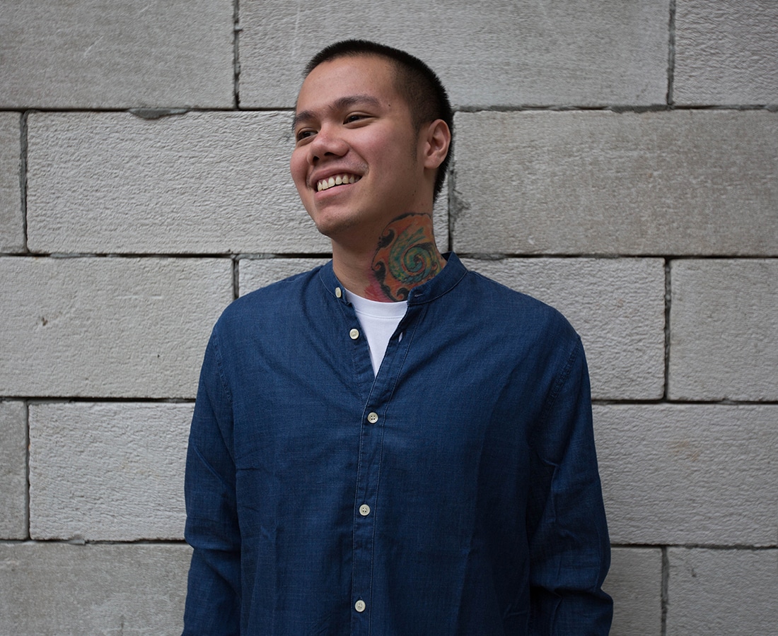an image of archie dennis against a concrete wall background 