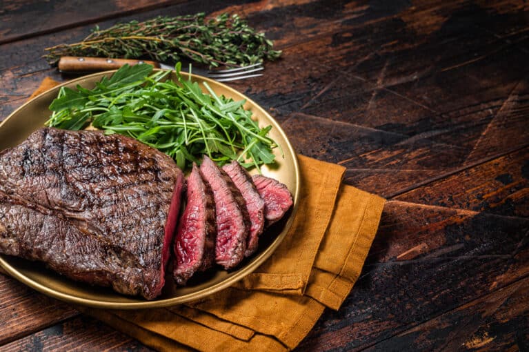 A sirloin beef steak served with salad.