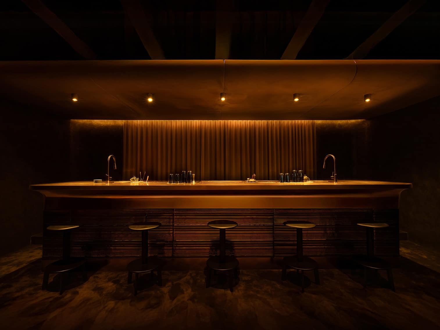 Minimalist and moody bar counter at CODA Singapore, spotlighting its sleek bottle-free aesthetic and intimate, immersive cocktail experience focused on Asian spirits.