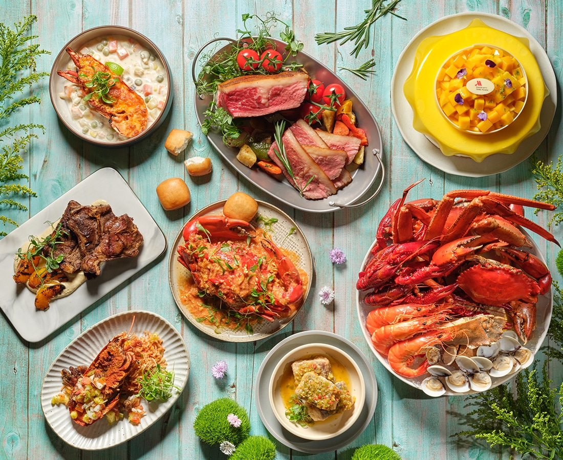 Seafood and meat selections from Crossroads Buffet at Singapore Marriott Tang Plaza Hotel, showcasing The Great Lobster Feast with lobster thermidor, crab, roast meats, and tropical desserts.