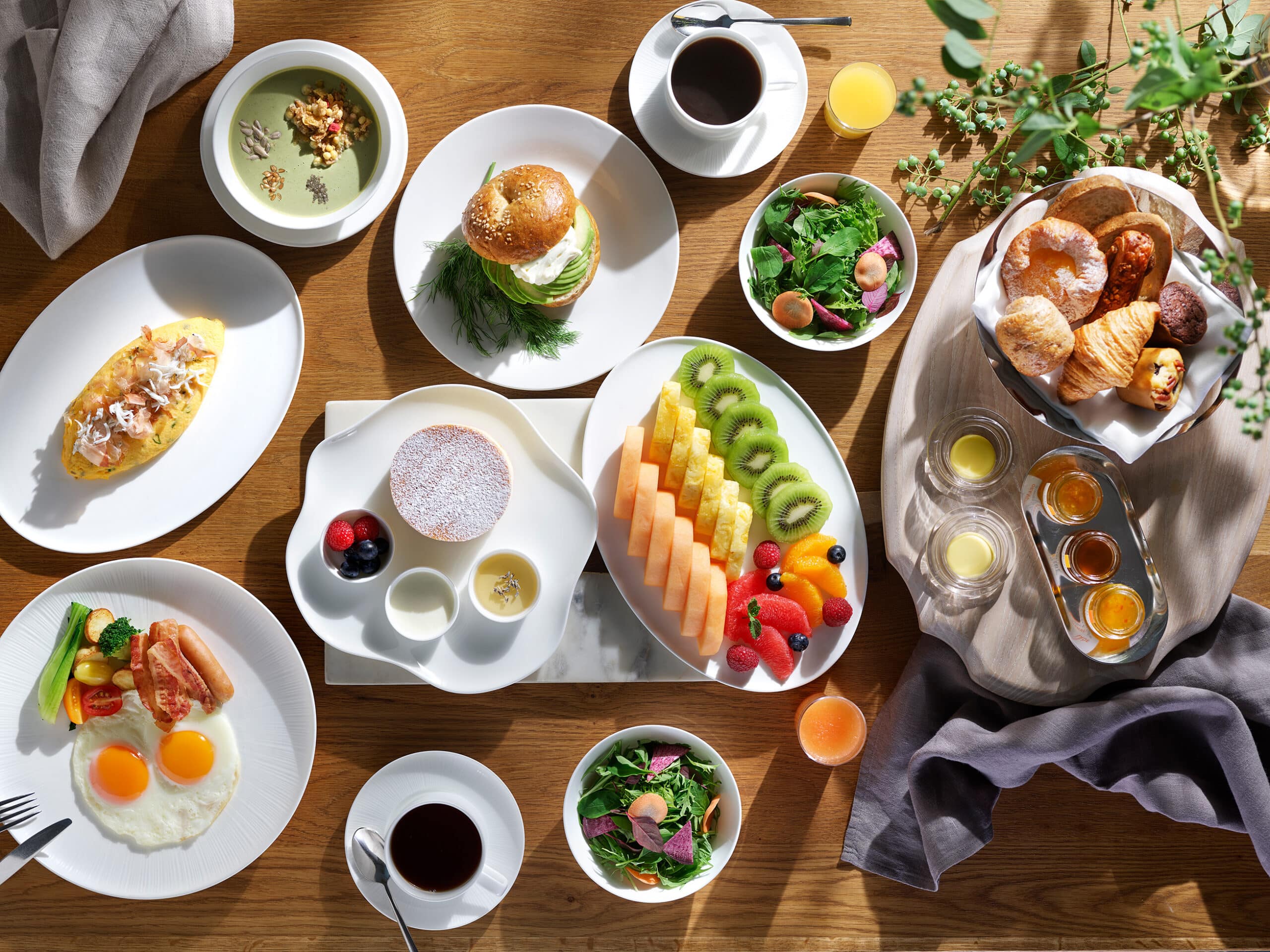 A vibrant wellness breakfast spread at The Westin Yokohama's Pacific Table, featuring fresh seasonal fruit, soufflé pancakes, salads, pastries, and matcha yogurt – reflecting the hotel’s 'Eat Well' philosophy.