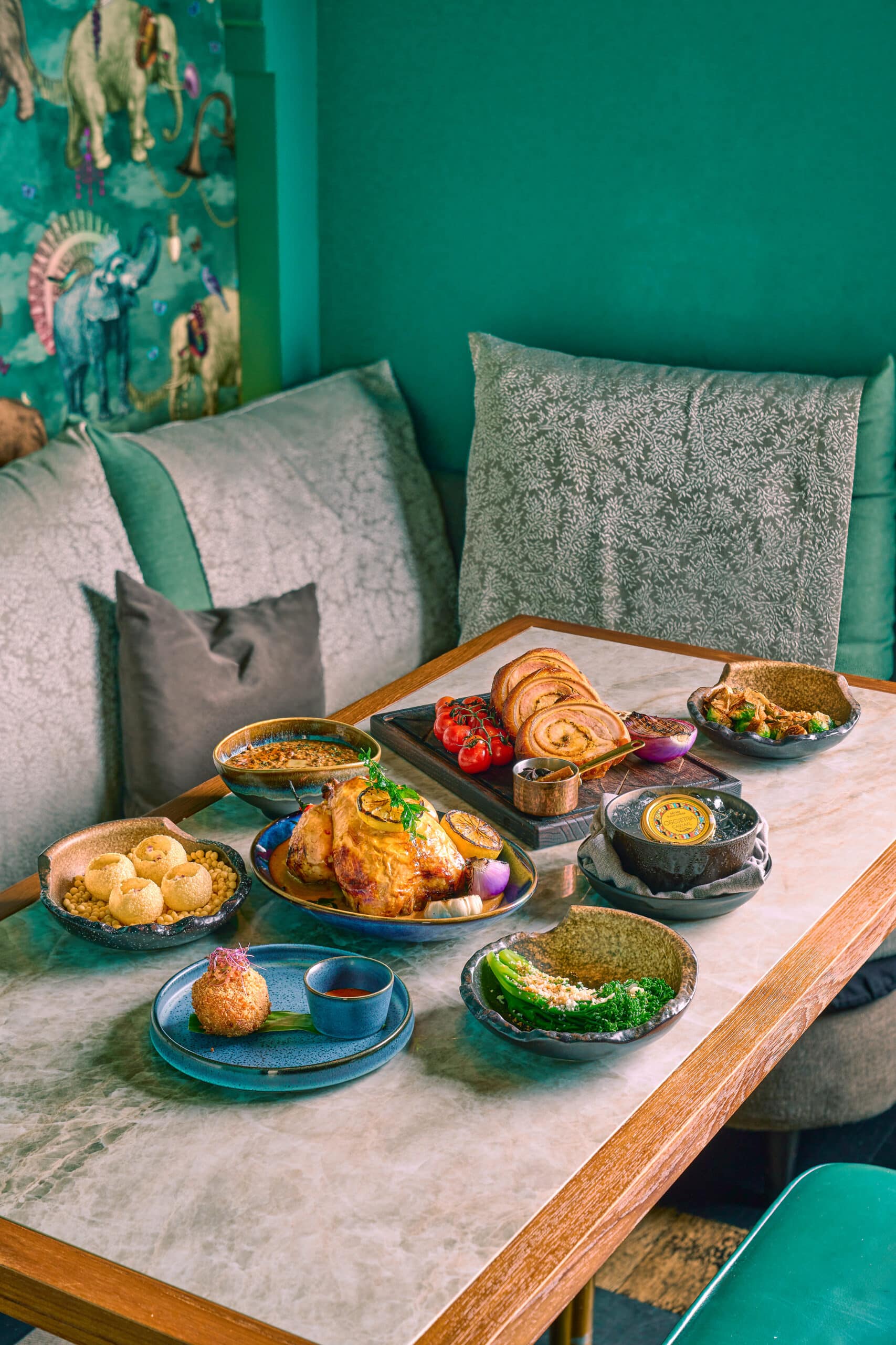 Modern Indian Christmas feast by Firangi Superstar, with porchetta, whole roasted chicken, and festive sides — available for dine-in and takeaway for company Christmas dinners.
