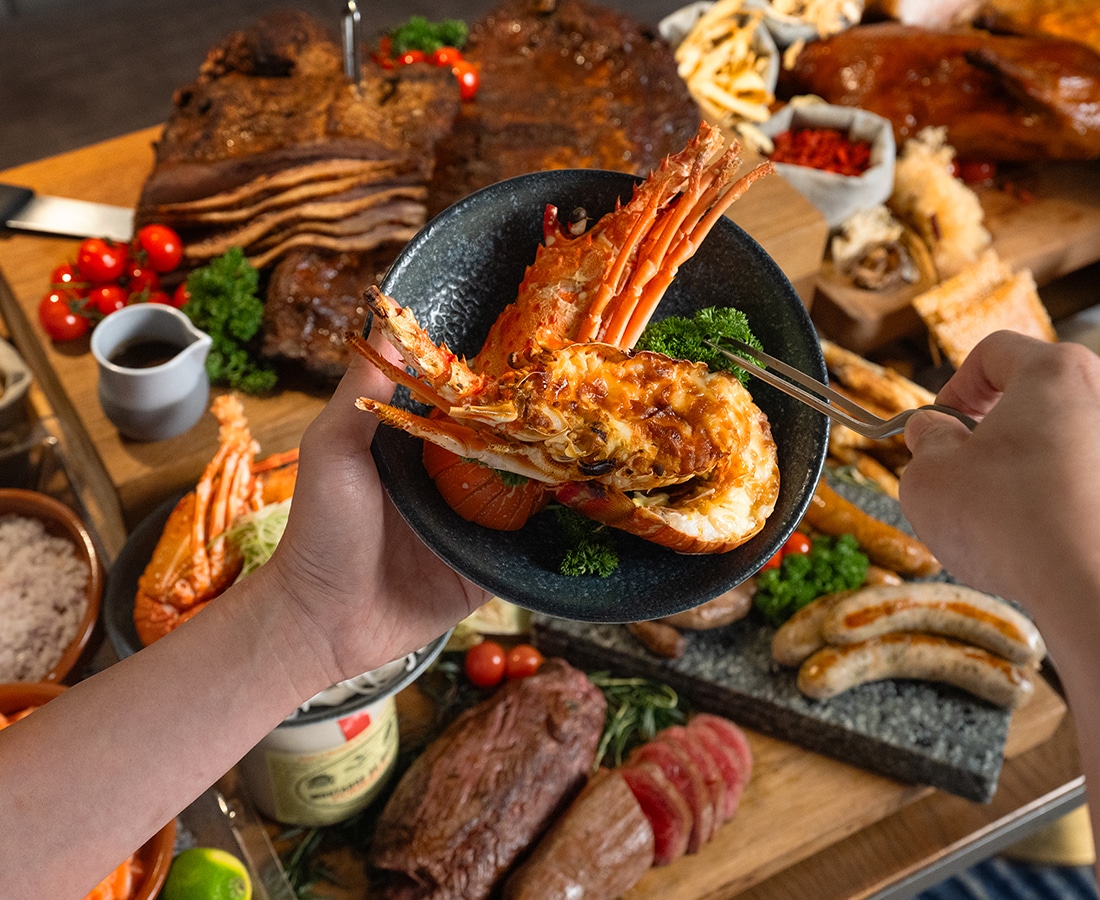 Estate's Lobster, Wagyu & Champagne Sunday Brunch at Hilton Singapore Orchard with grilled lobster, roast beef, sausages, and live carving stations.