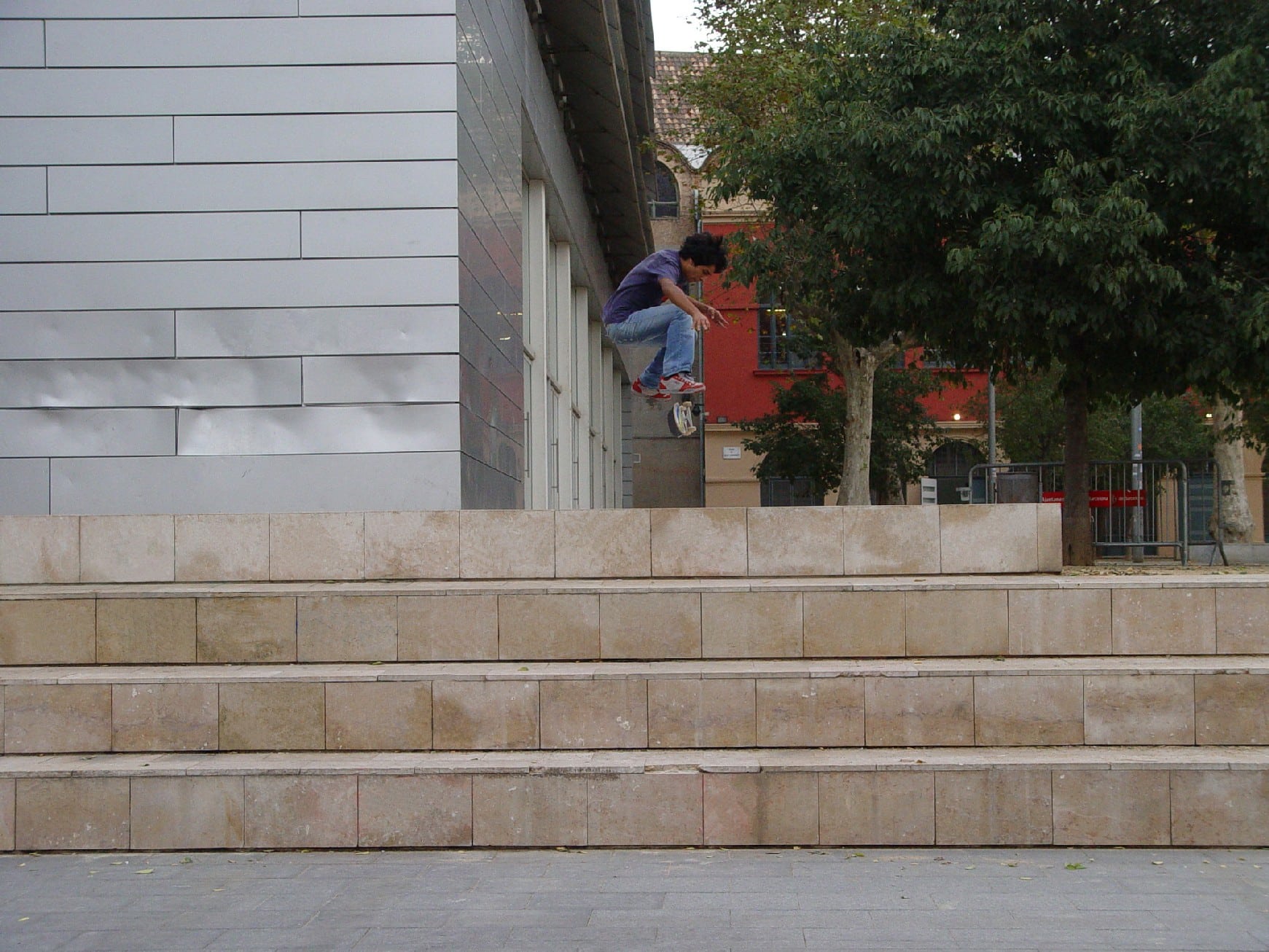 Marco Antão performing a skateboarding trick at Macba's stairs in Barcelona.