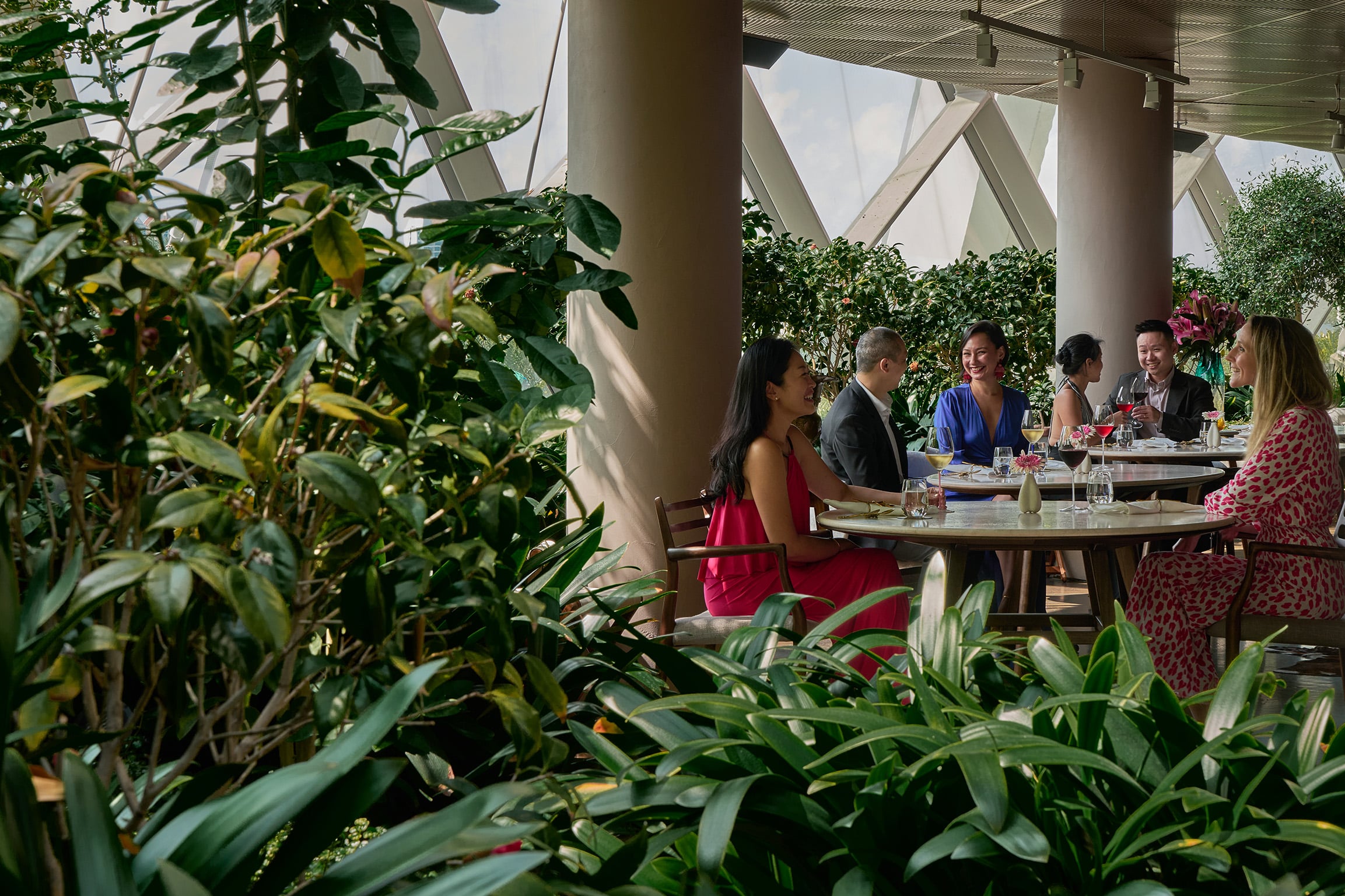 Elegant lunch setting at Marguerite, Gardens by the Bay, with natural light, lush greenery, and refined tasting menus.