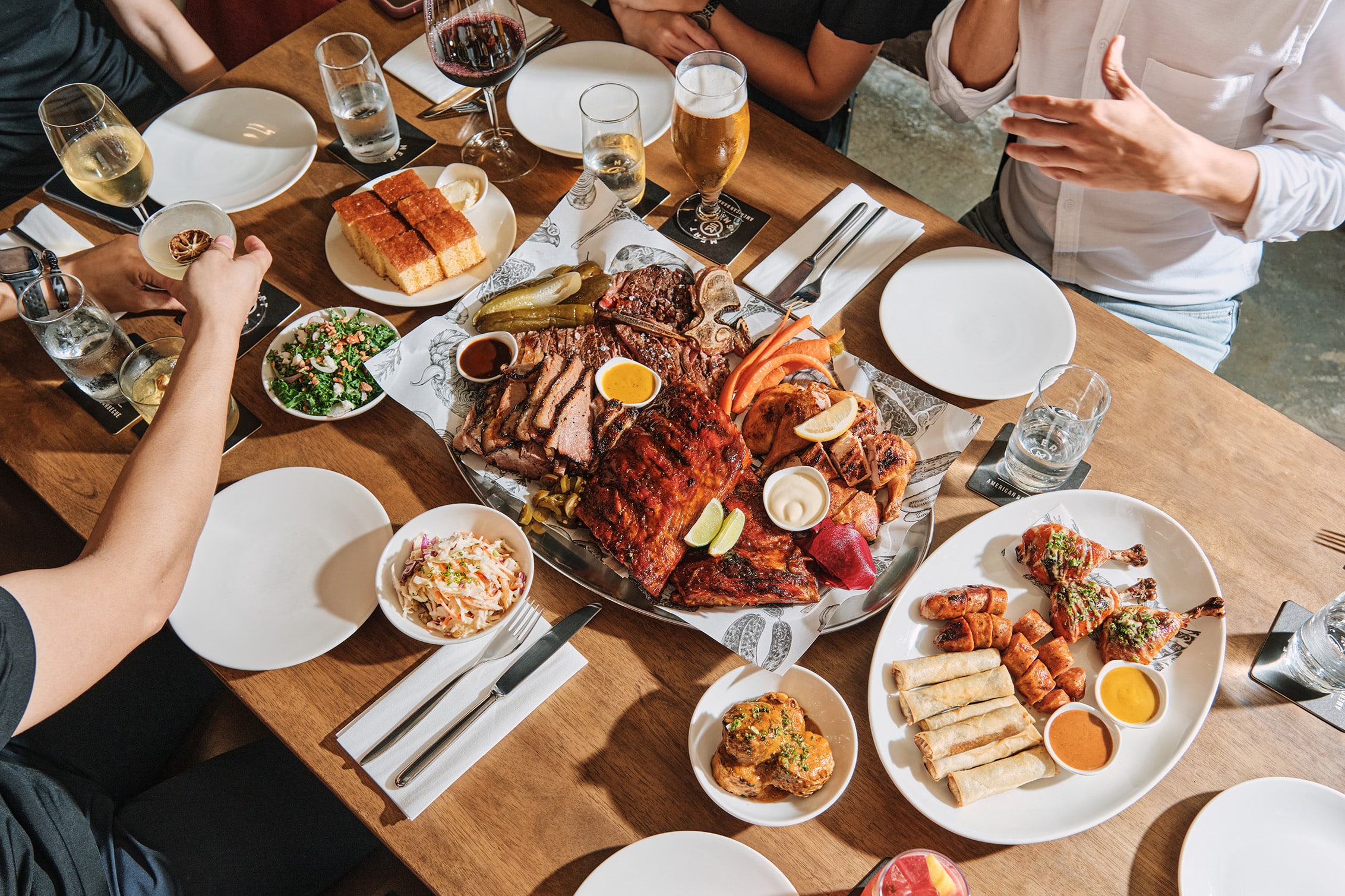 Meatsmith’s smoked meat platter featuring ribs, brisket, and cornbread, a bold, crowd-pleasing option for company Christmas dinners in Singapore.