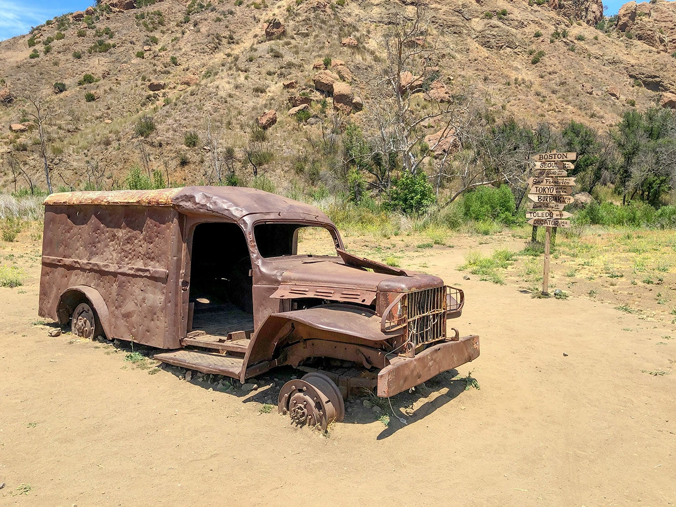 A vintage camper van parked along a California coastline at sunset, capturing the freedom of road trips and off-grid camping adventures by the Pacific Ocean.