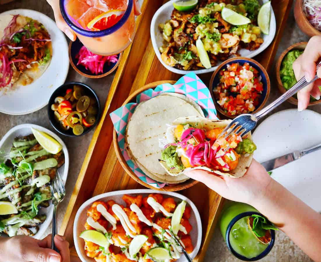 Colourful spread of tacos, guacamole, and margaritas at Super Loco Singapore, known for its vibrant Mexican happy hour deals.