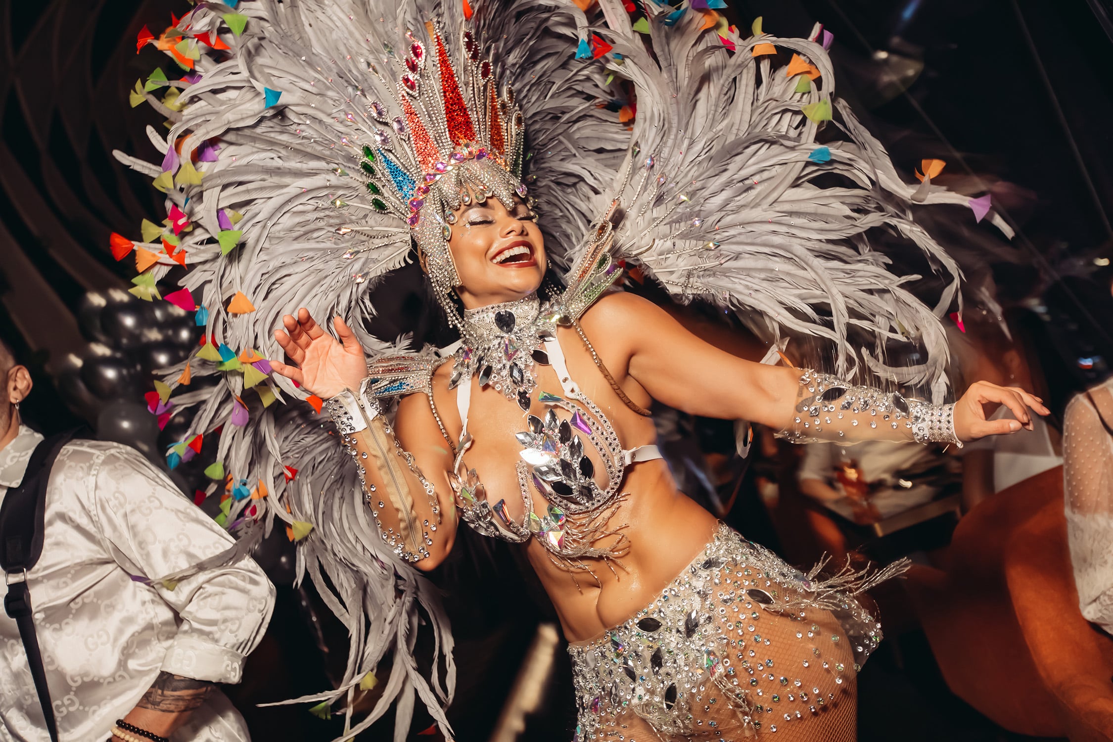 Samba dancer in vibrant costume performing at SUSHISAMBA Singapore’s all-white NYE party