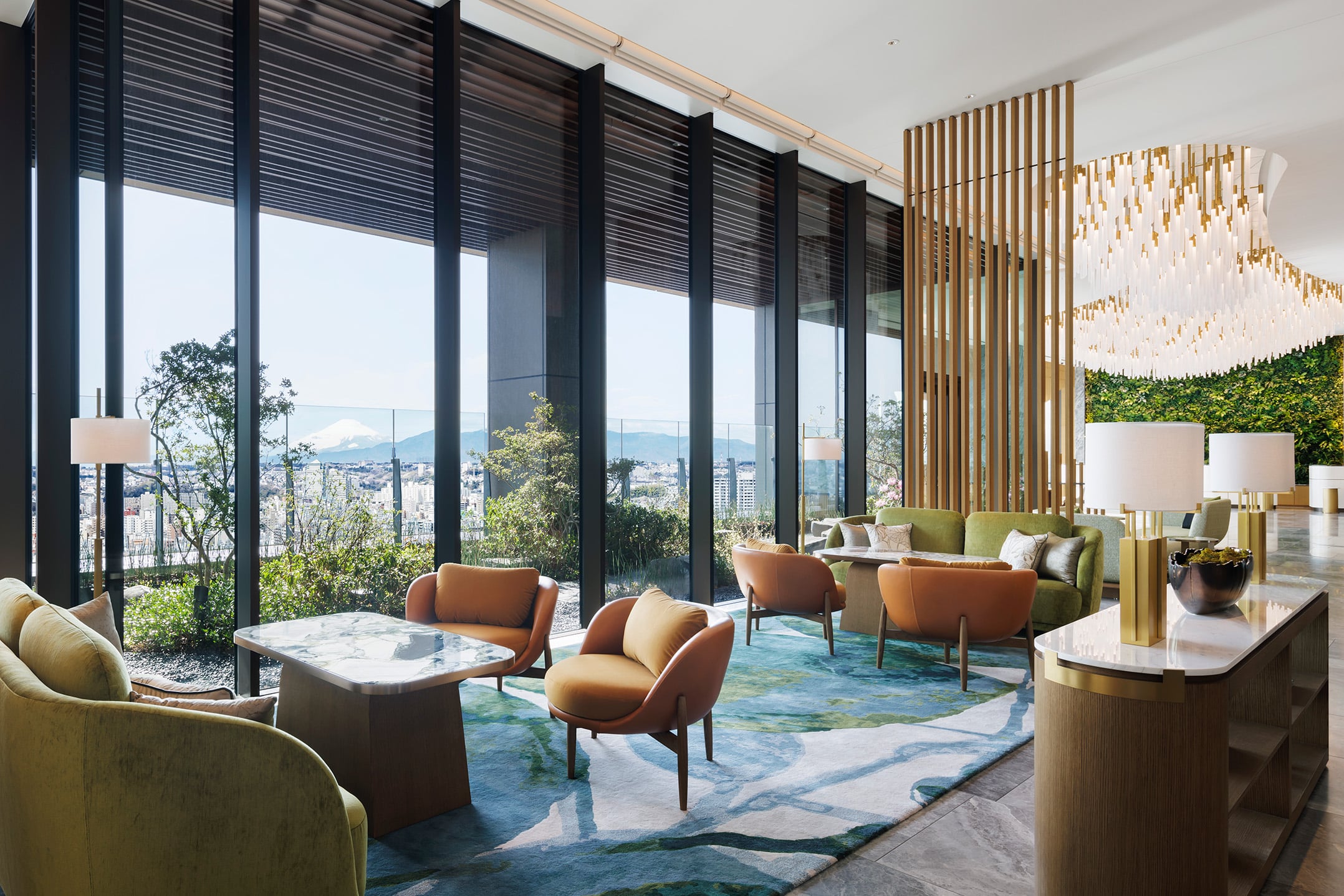 The lobby lounge at The Westin Yokohama, framed by floor-to-ceiling windows, lush greenery, and a view of Mt. Fuji – a serene welcome into the hotel’s biophilic design.